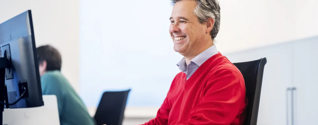 close up of a man working at a desk