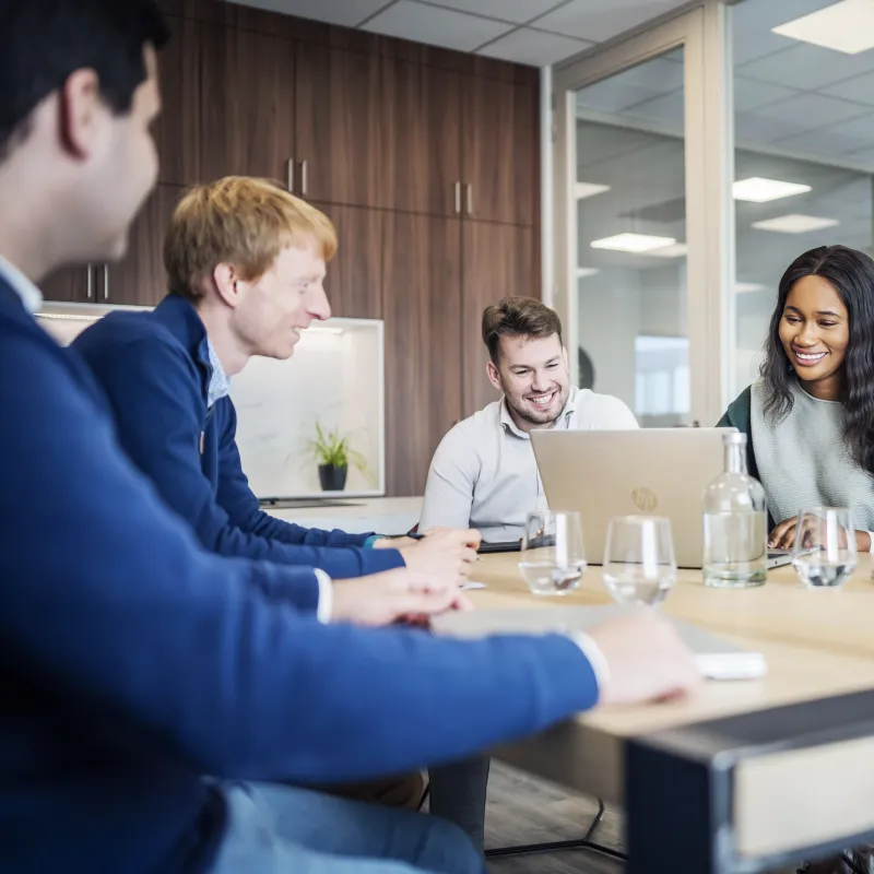 five people at the table in a meeting room