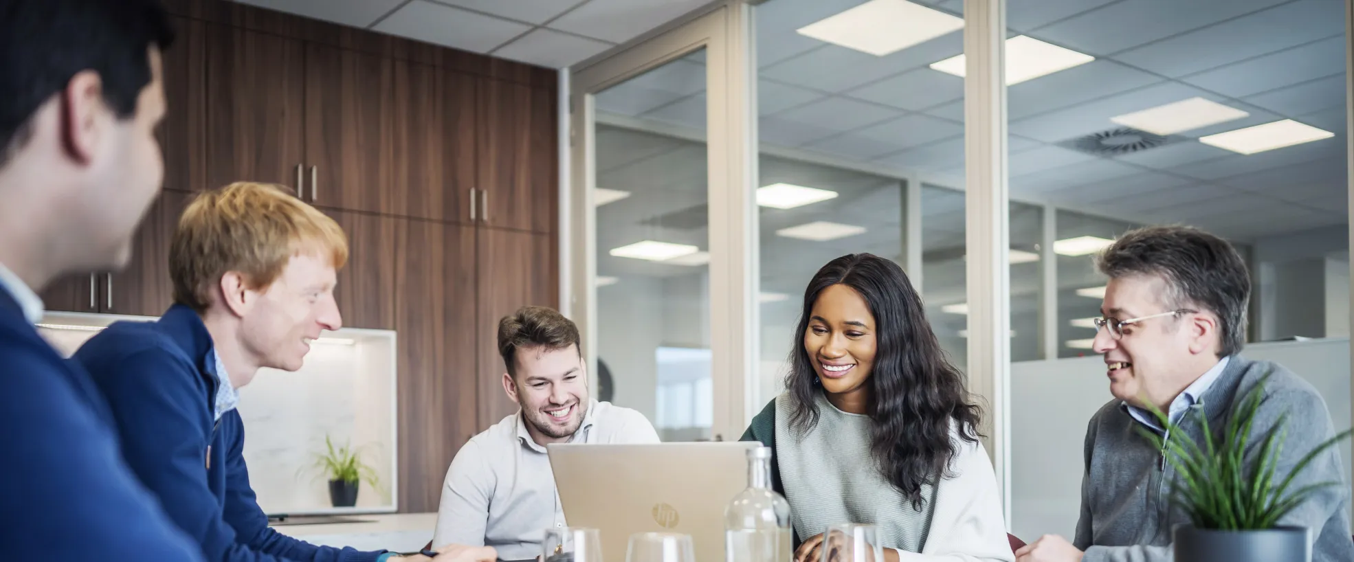 five people at the table in a meeting room