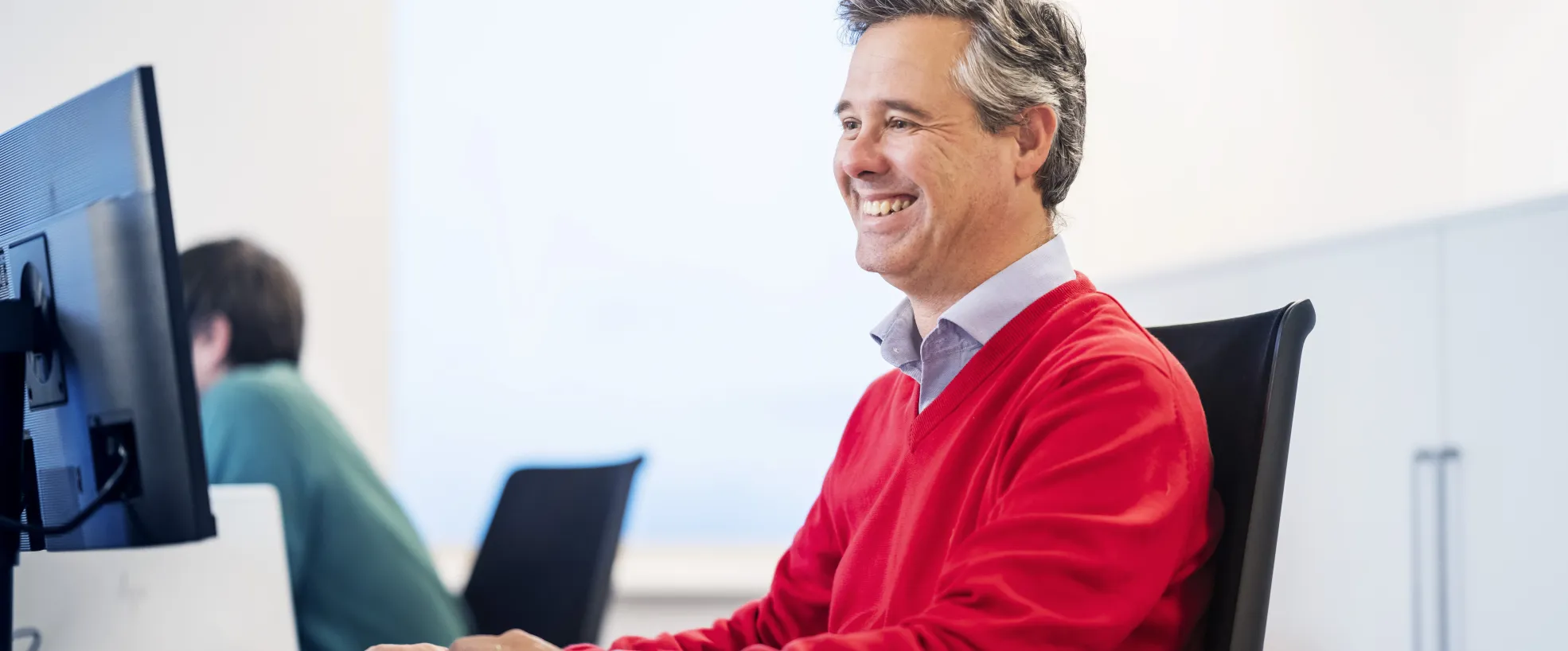 close up of a man working at a desk